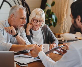 Couple reviewing finances with advisor