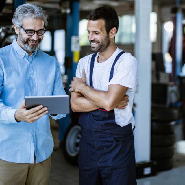 Mechanic reviewing estimate with customer