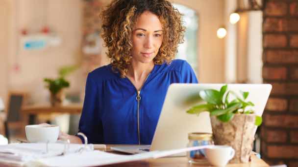 Business owner reviewing financials in a coffee shop